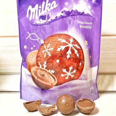 Фото - шоколад молочний в формі кулі з центром з молочного шоколаду і горіхової пасти з фундука Milka